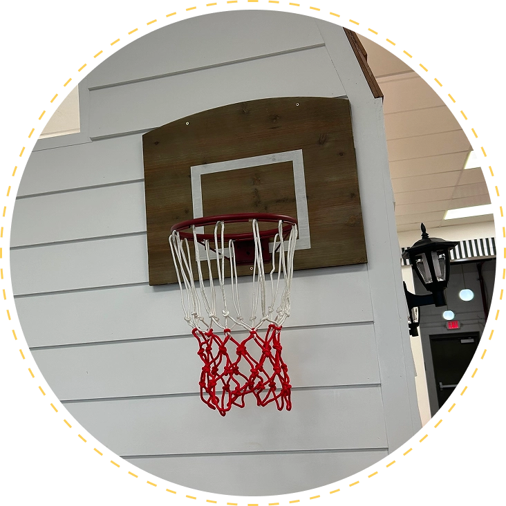 A basketball hoop with a red net mounted on a white wall.