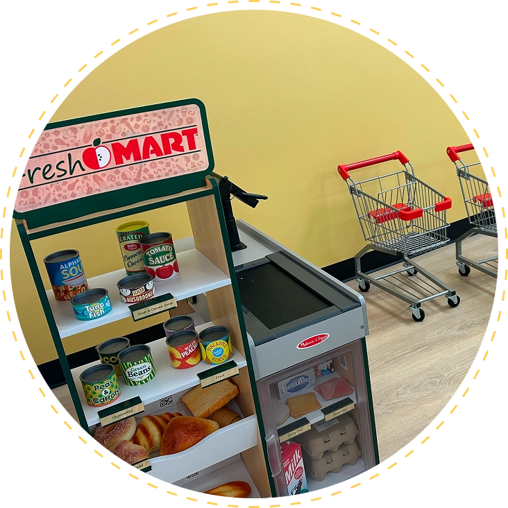 Miniature grocery store display with tiny shopping carts.